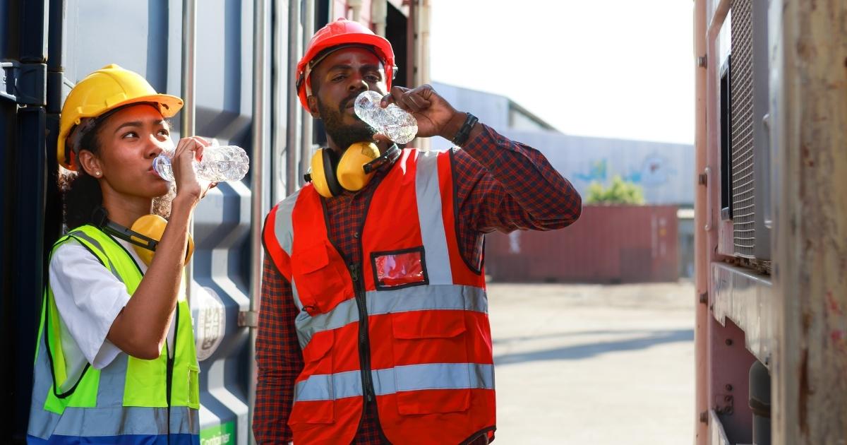 workers drinking water during heat wave