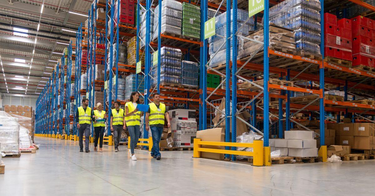 group of new workers walking through warehouse