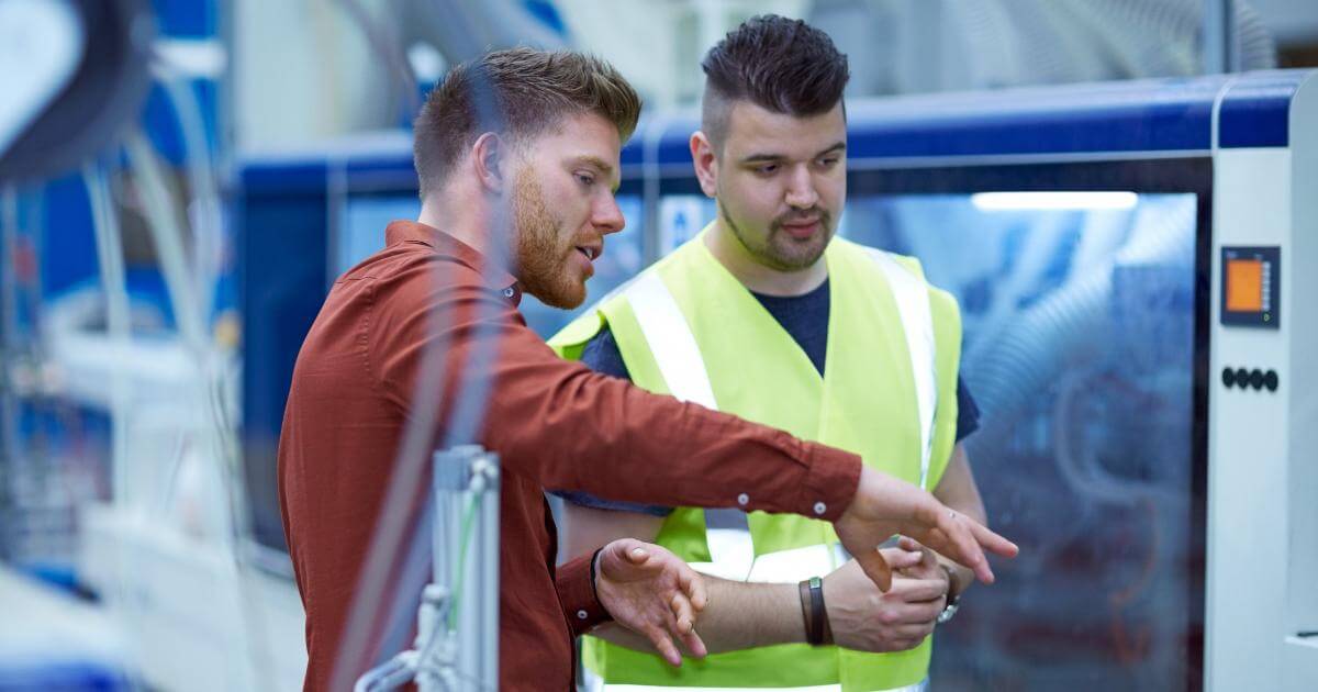 manufacturing plant manager talking to employee