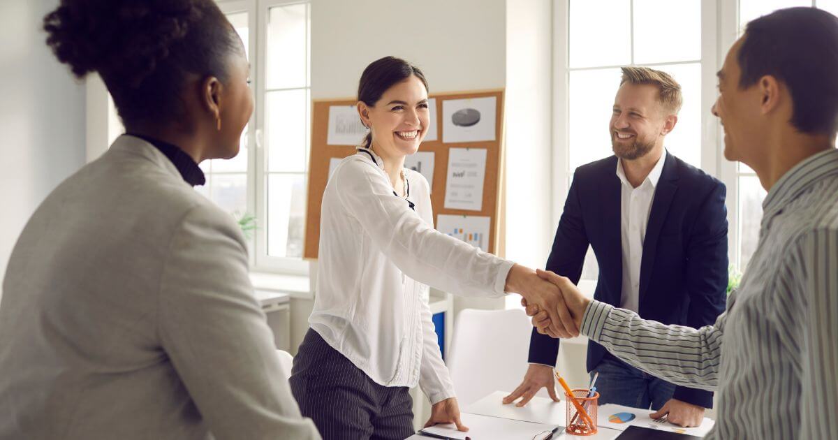 Employer and staffing partner shaking hands after discussing administrative hiring needs